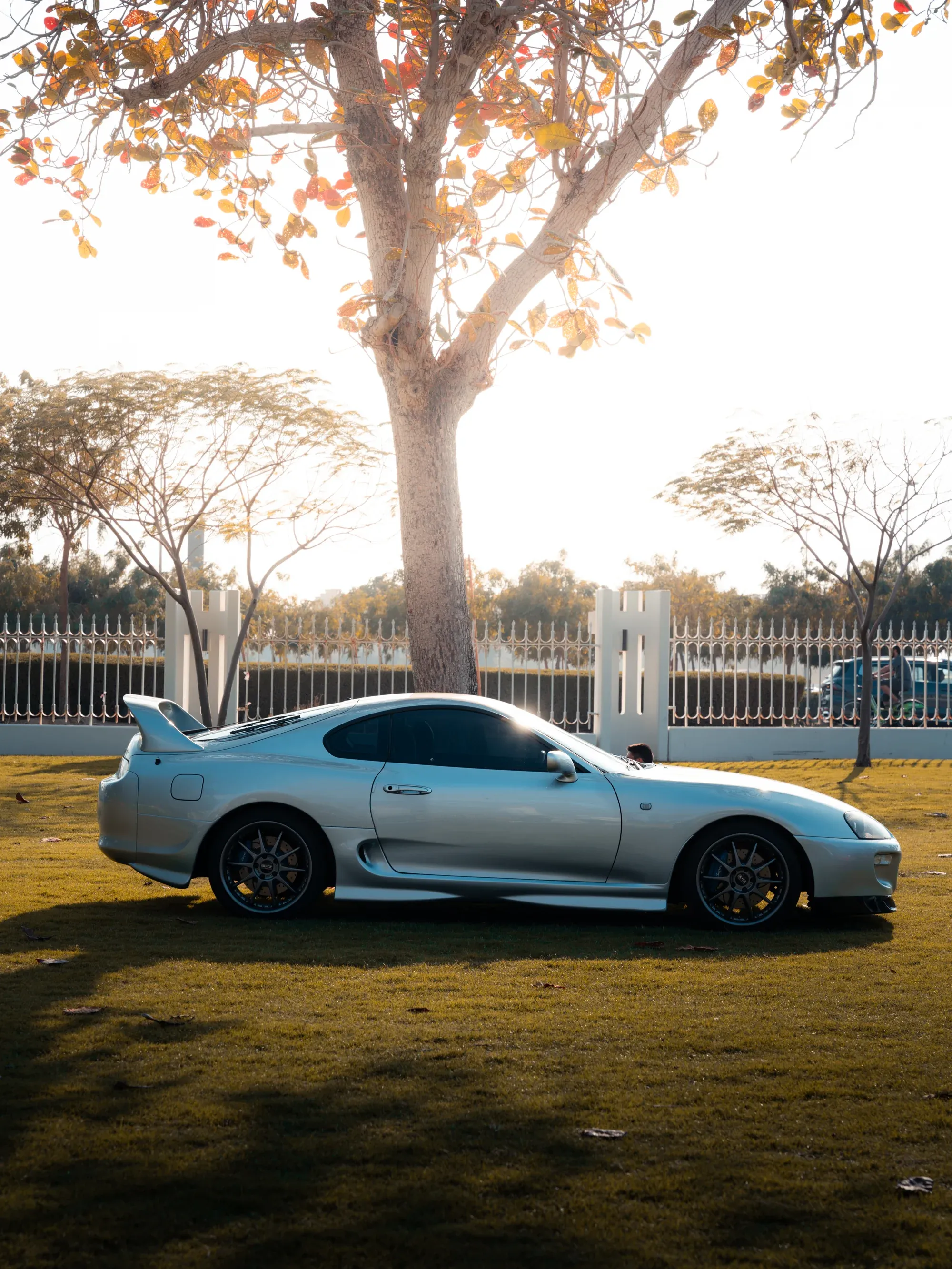 Car show attendees admiring a vintage sports car.