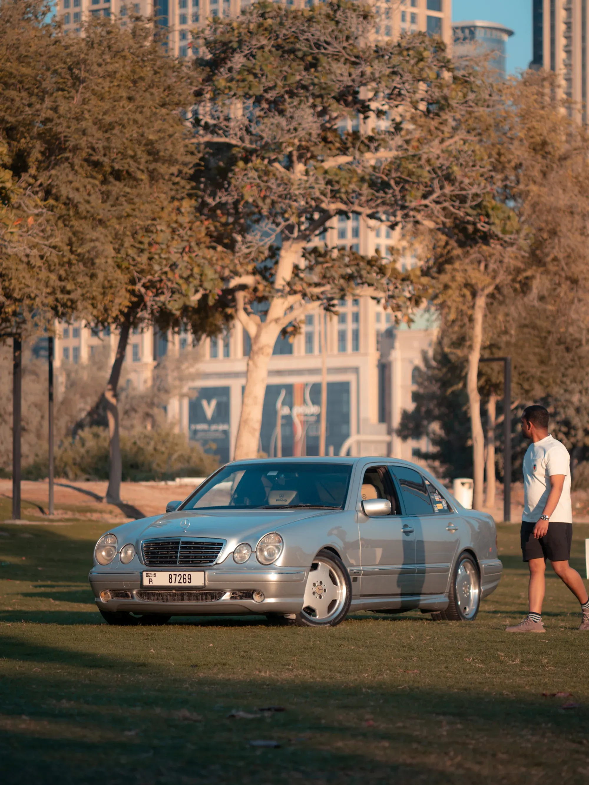 Close-up of Mercedes headlight, sharp focus with soft bokeh.