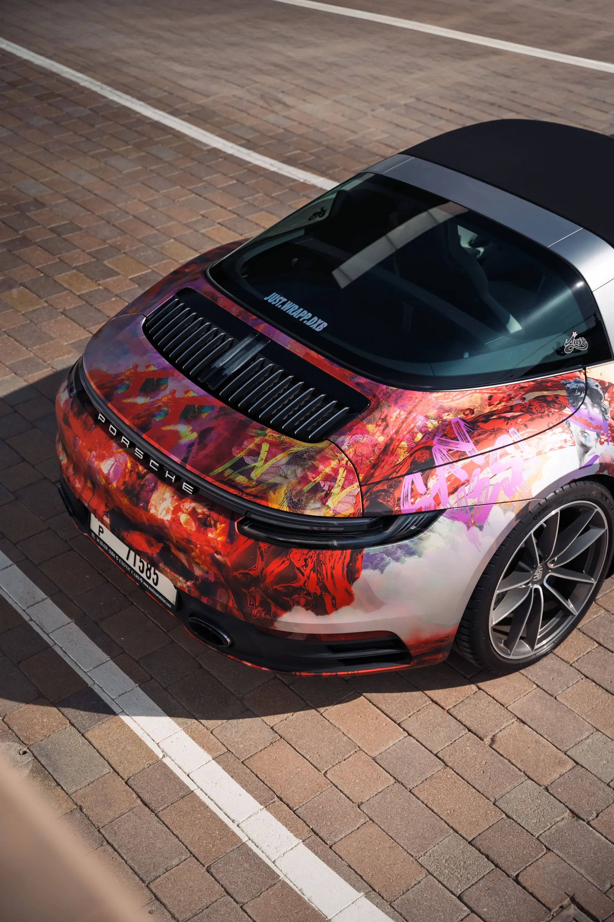 Close-up of car wheels and rims, high contrast lighting.