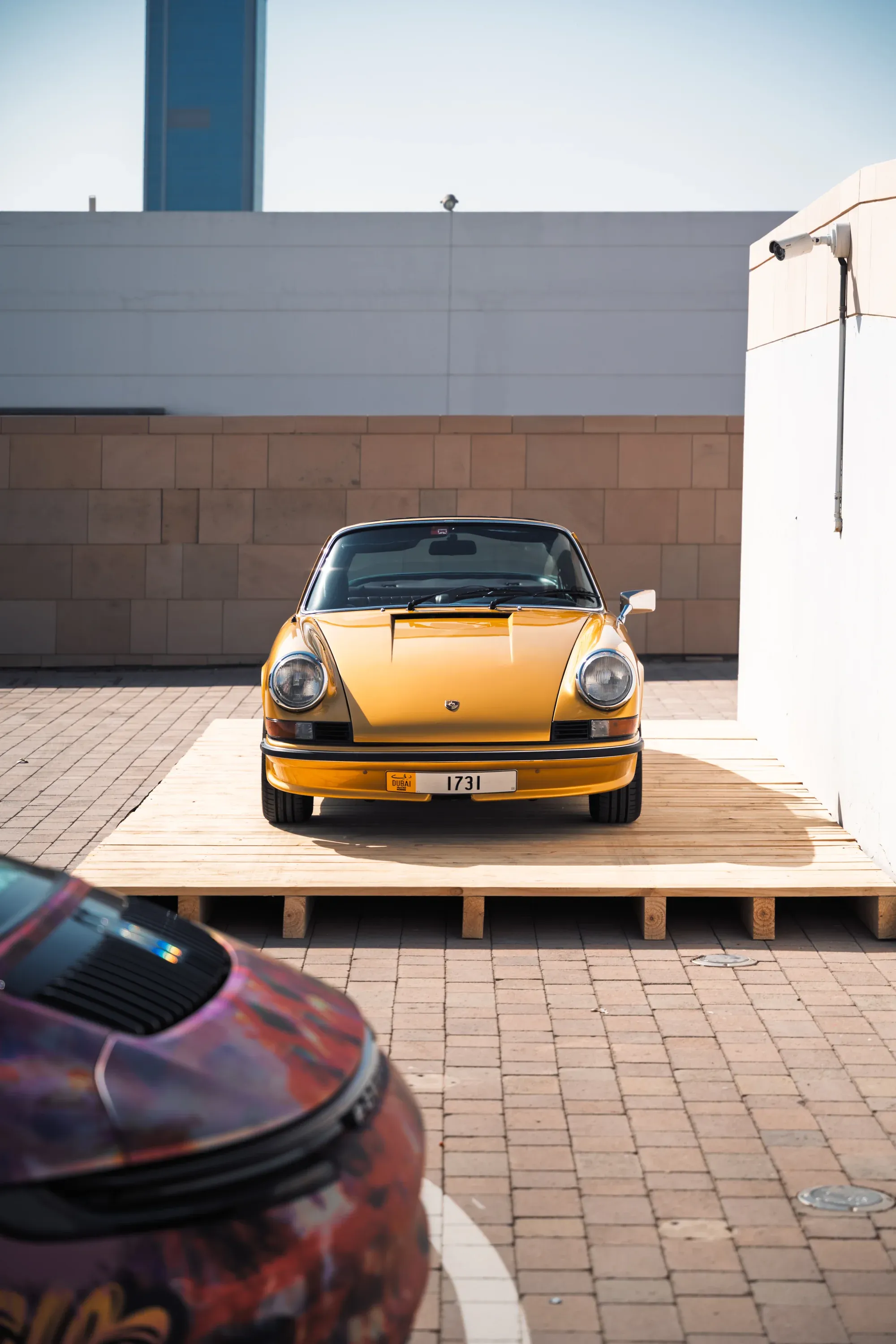 Silver Mercedes grill and emblem detail, moody lighting.