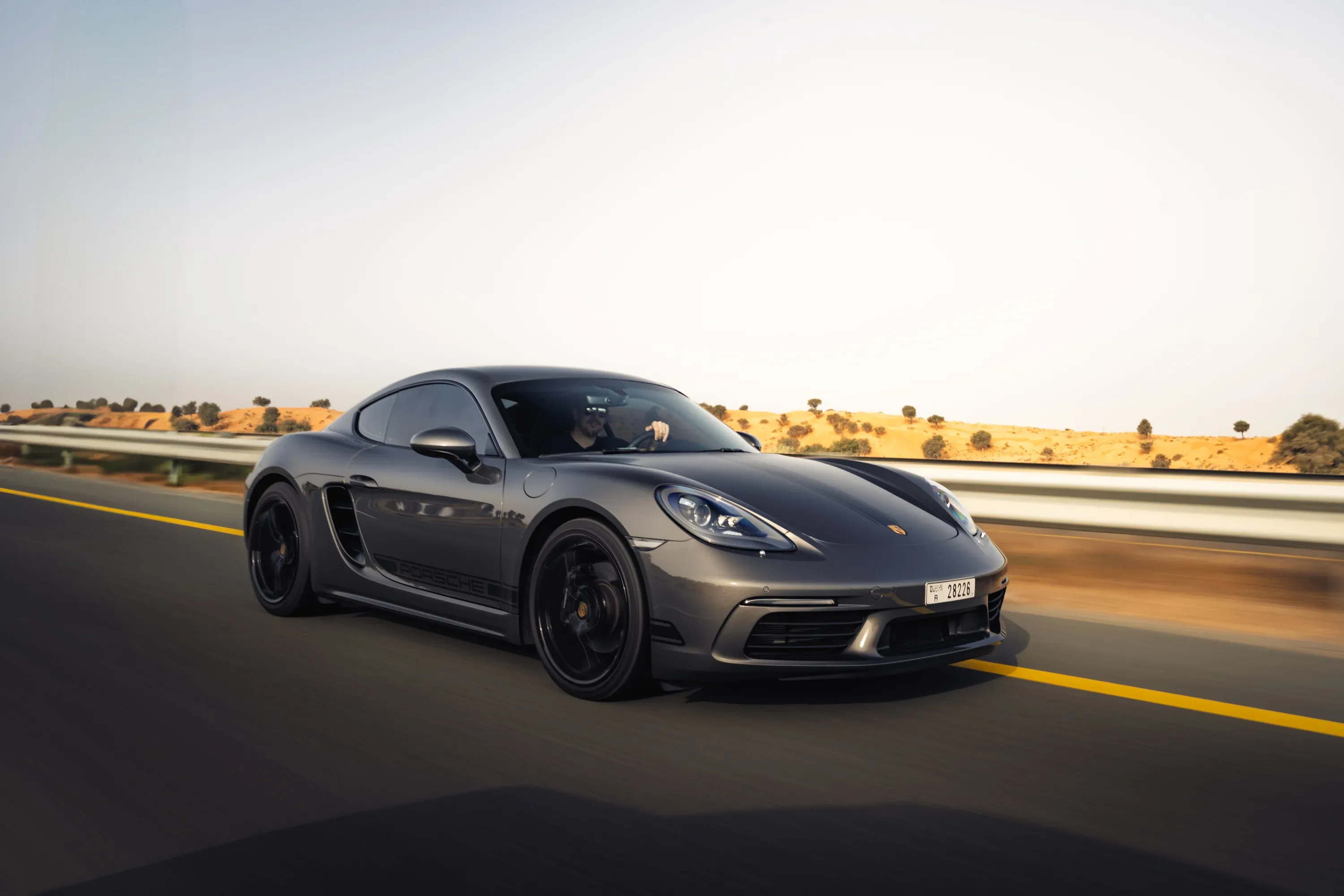 Close-up of car door handle and sleek lines, metallic finish.