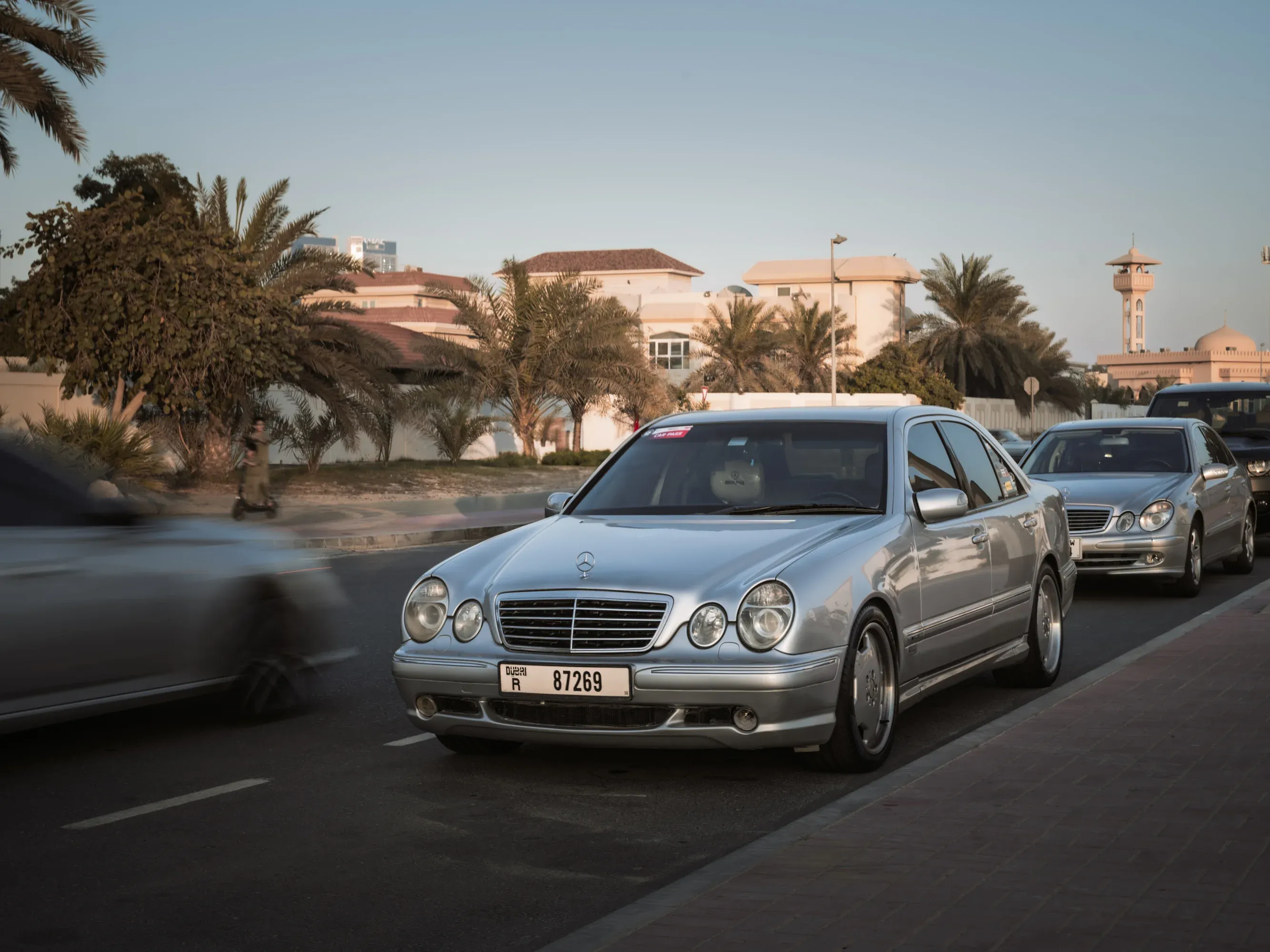 Interior view of classic car steering wheel and gauge.
