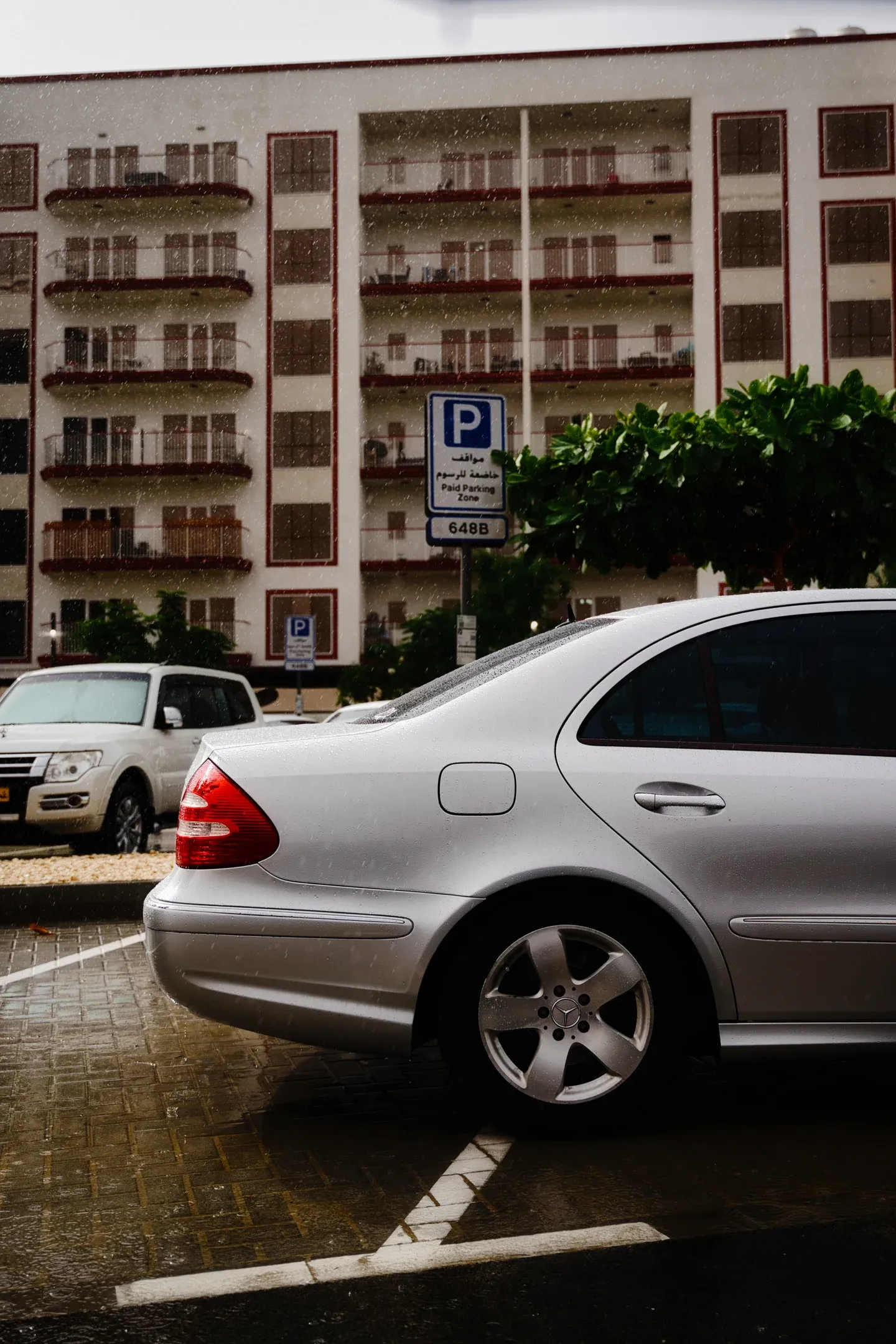 Stormy silver: Raindrops bead on the classic lines of the W211 E-Class in the heart of Dubai.