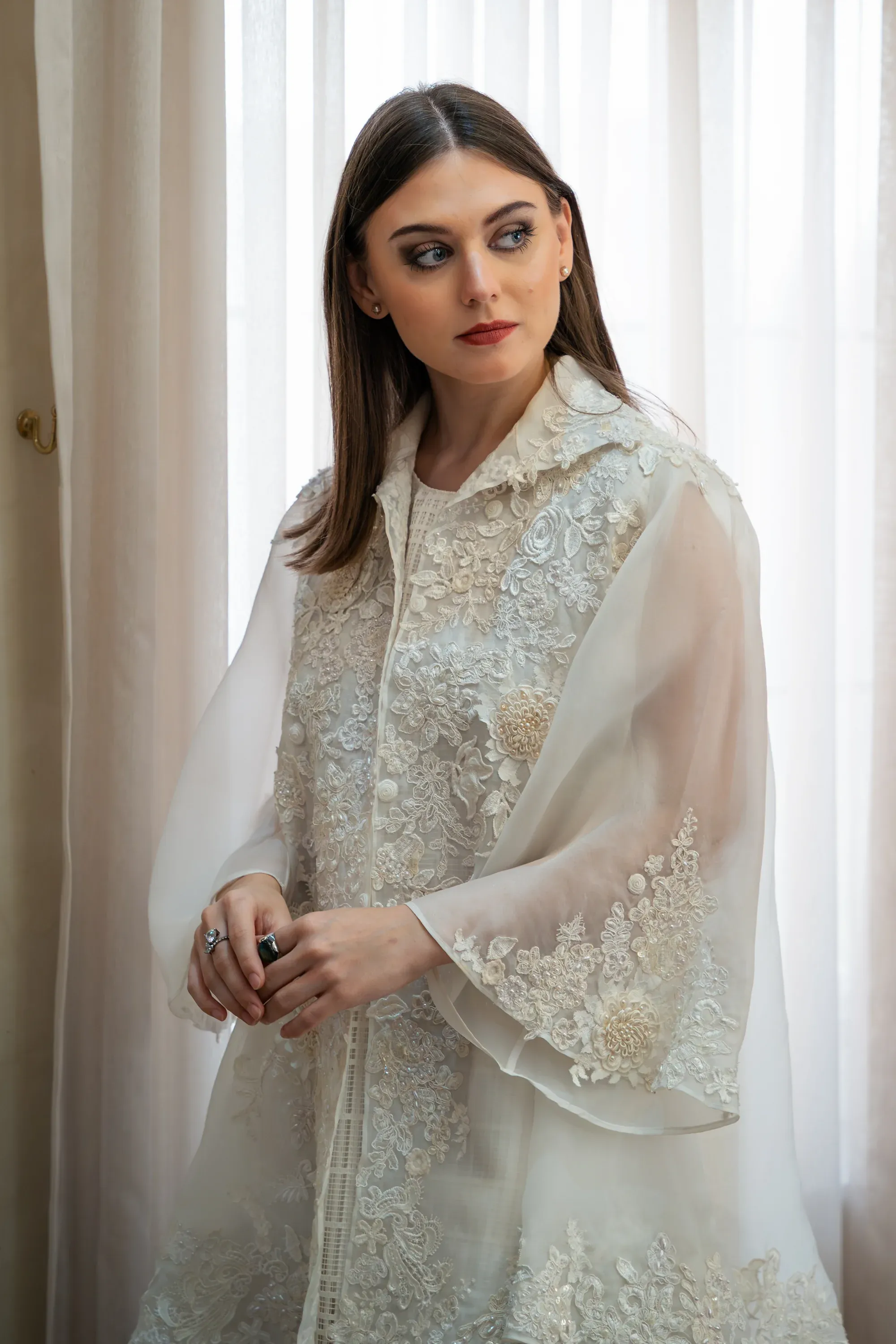 Full-length fashion shot in an urban environment.