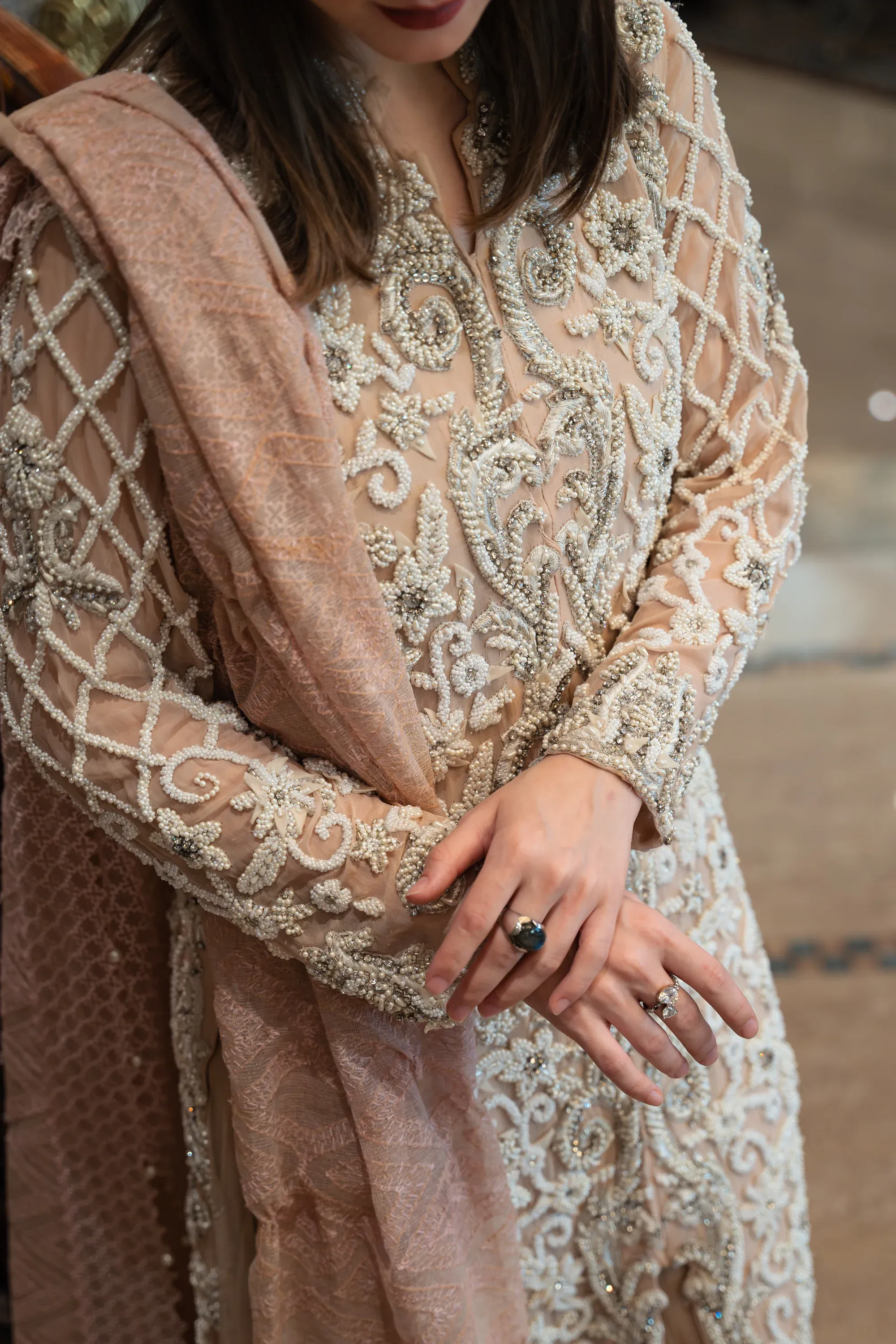 Model posing against a textured wall, industrial vibe.