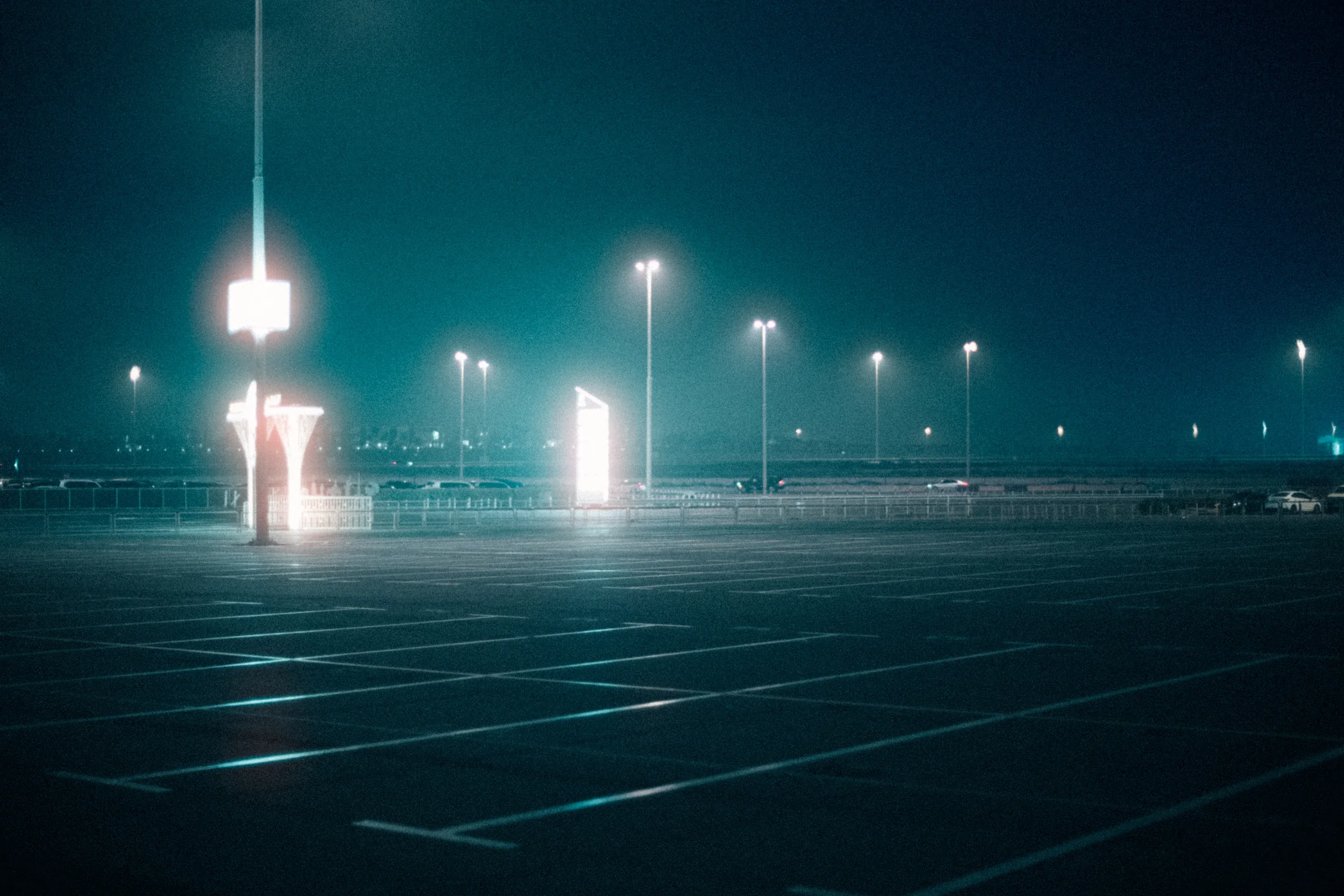 Empty city alleyway after rain, reflective surfaces.