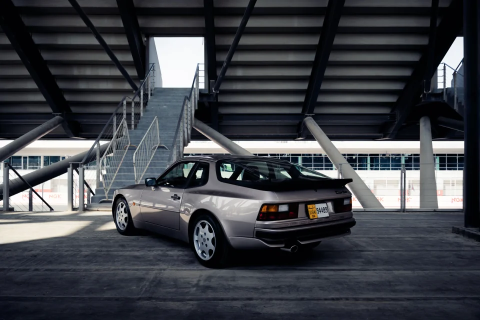A silver Porsche 944 beneath the grandstand at Dubai Autodrome